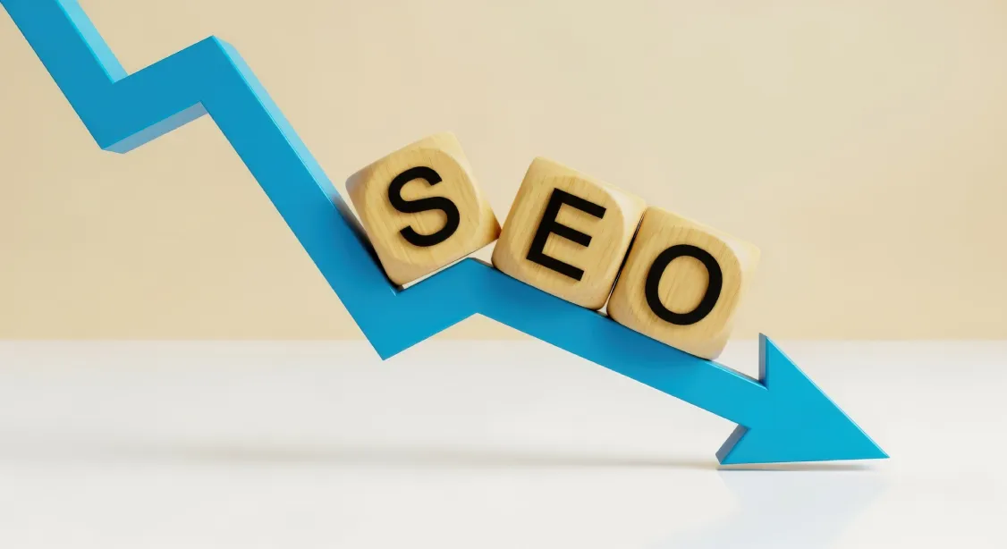 SEO blocks sliding down a declining arrow representing search ranking loss that signals a Phoenix website redesign is needed