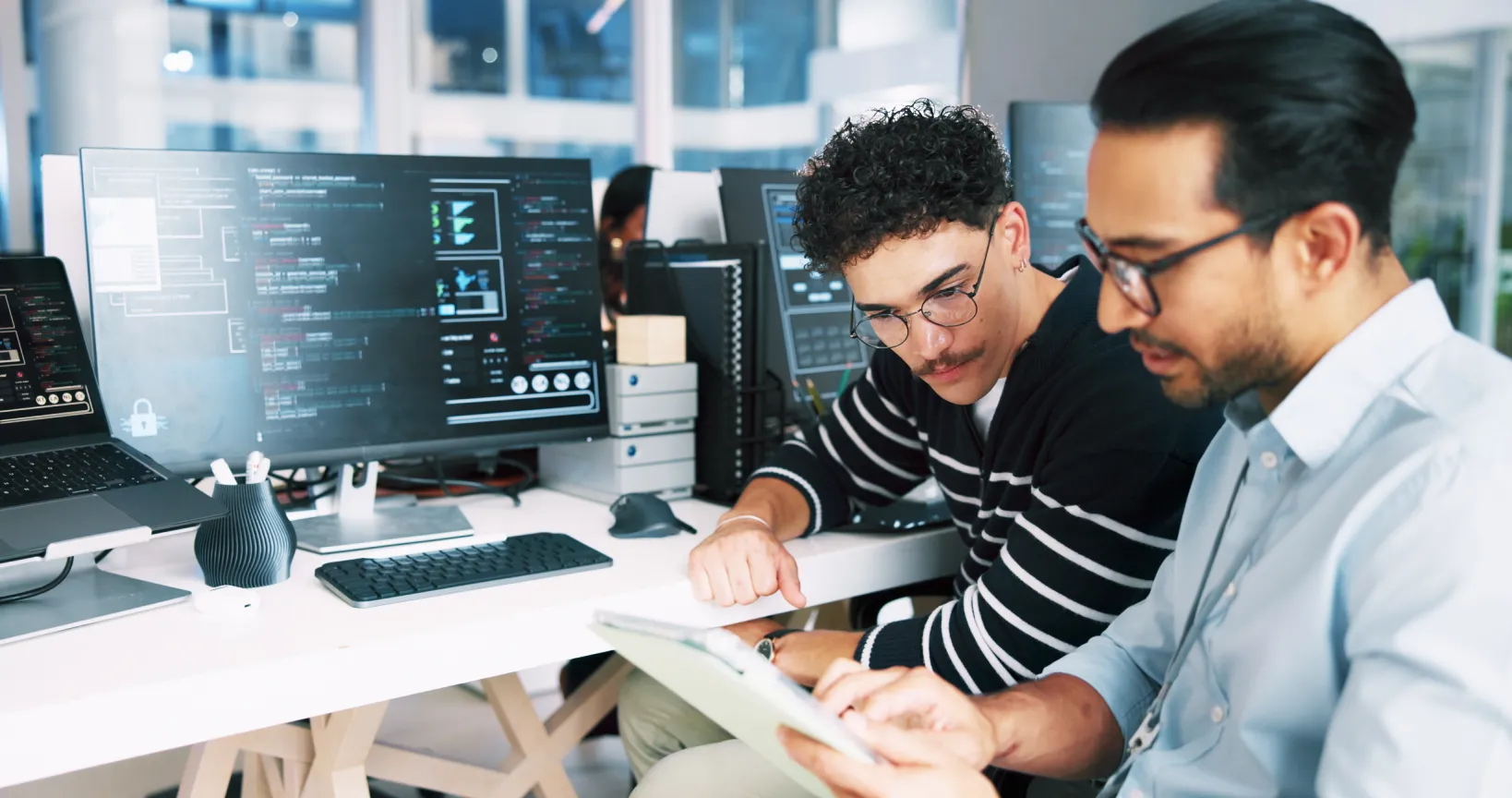 IT technicians reviewing systems together, representing a dedicated team from a trusted managed IT provider