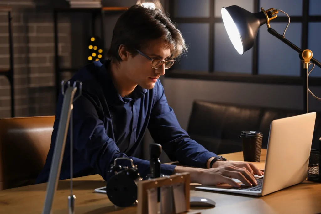 Single IT person working late alone on a laptop